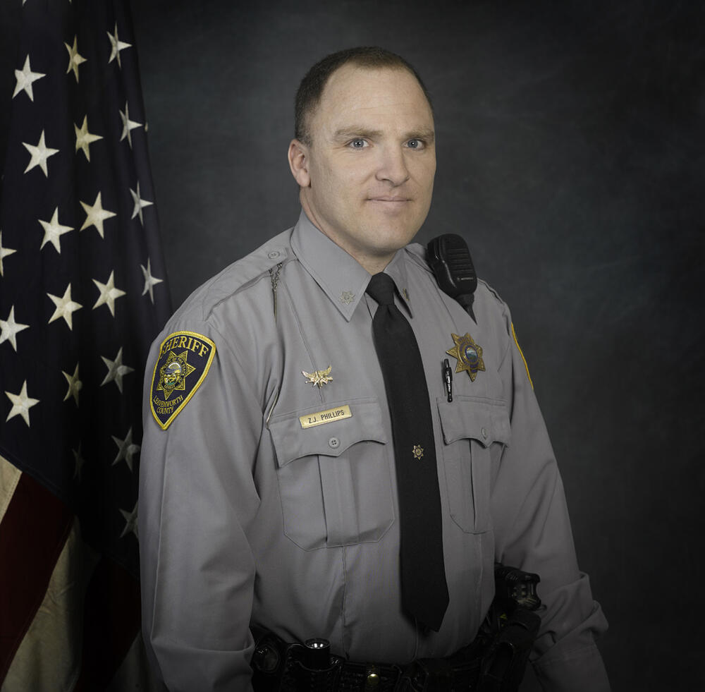 deputy phillips in grey sheriff's office uniform